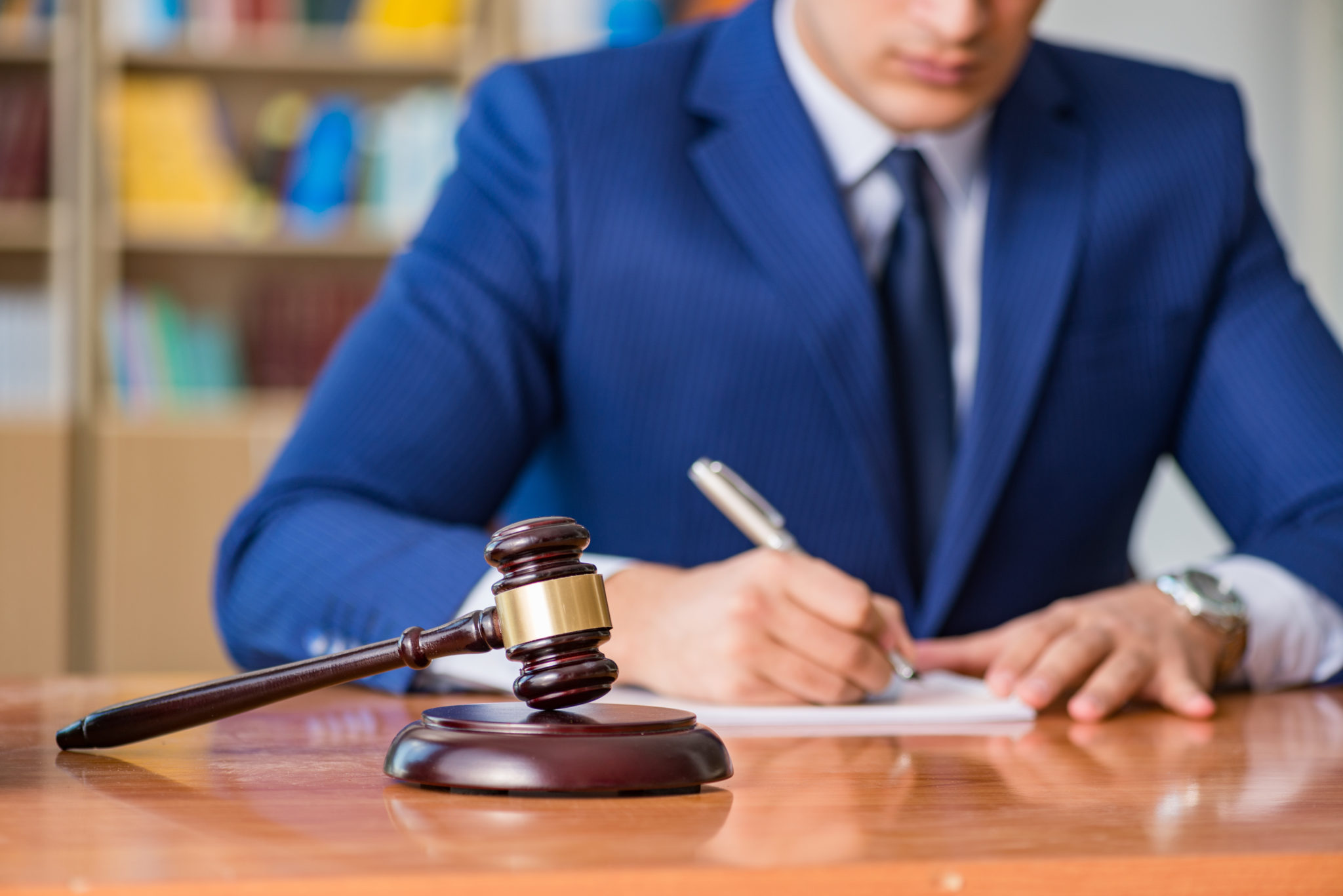 judge in blue suit with gavel