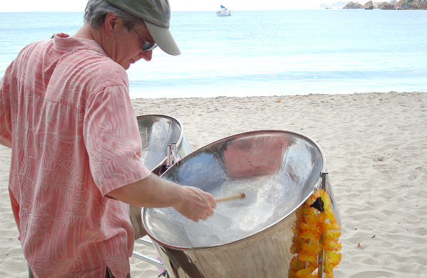 Man Playing Steel Drums On Beach